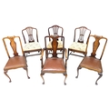 A dining table and six chairs, comprising two sets of three dining chairs comprising three with vase... 