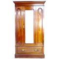 A Victorian mahogany wardrobe, with single bevelled mirror door enclosing a hanging space, and singl... 
