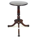 A mahogany wine table, the circular surface with moulded edge, raised on a turned column and three c... 