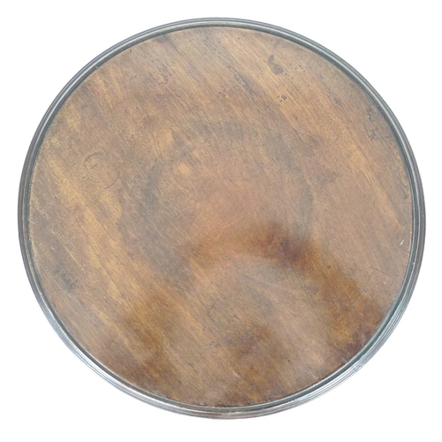 202 - A mahogany wine table, the circular surface with moulded edge, raised on a turned column and three c... 