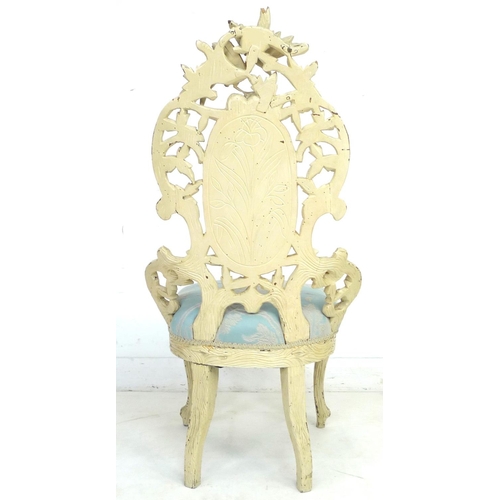 207 - A Victorian nursing chair with cream painted carved frame, raised on cabriole legs to the front and ... 