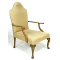 An Edwardian mahogany open armchair, in Queen Anne style, upholstered in cream foliate fabric, 72 by... 