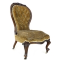 A Victorian button back nursing chair, with walnut  carved top-rail, upholstered in olive velvet, 75... 