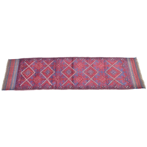 223 - A red ground Meshwani runner, with flat weave ends, 240 by 61cm.