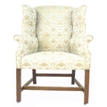 A Georgian style wing armchair, pale green and gold velour, 74 by 82 by 110cm high.