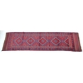 A red ground Meshwani runner, with flat weave ends, 224 by 57cm.