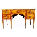 A George III mahogany and fan paterae inlaid sideboard, with five drawers, brass ring handles, raise... 