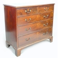 A George III mahogany chest of two short over three graduating drawers, with brass swan neck handles... 