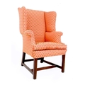 A Georgian wing armchair, of small proportions, upholstered in salmon pink and gold fabric, raised o... 