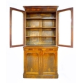 A Victorian mahogany and walnut veneered bookcase, twin glazed doors enclosing three shelves, twin a... 