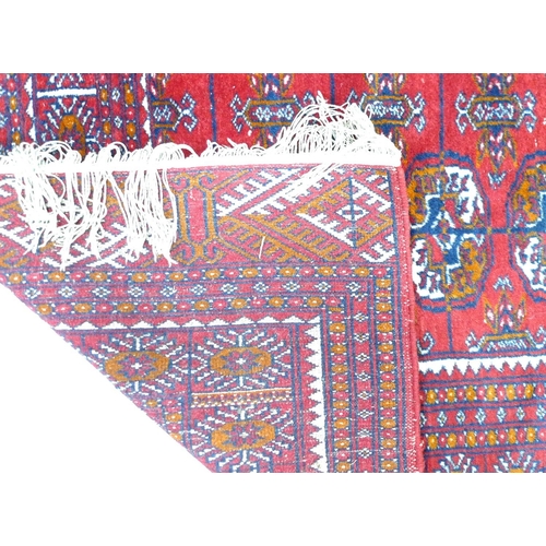 256 - A Tekke rug, with red ground, 130 by 200cm