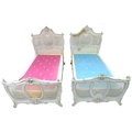 A pair of early 20th century cream painted single bed frames, in French Rococo style, with caned hea... 