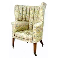 A George III wing armchair, with high 'ribbed' barrel back, upholstered in pale green, blue, pink an... 