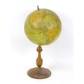 An early 20th century terrestial desk top Globe,  'The Earth' made by AK in Bavaria, with turned woo... 