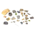 A collection of archaeological items, including a Roman white metal pin, found in Rodbridge, Long Me... 