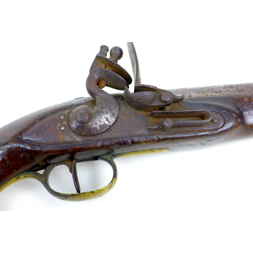 144 - An 18th century flintlock pistol, no visible maker's name, with walnut stock, white metal and brass ... 