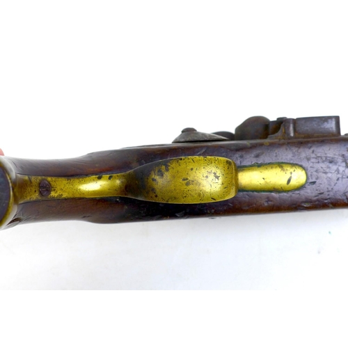 144 - An 18th century flintlock pistol, no visible maker's name, with walnut stock, white metal and brass ... 