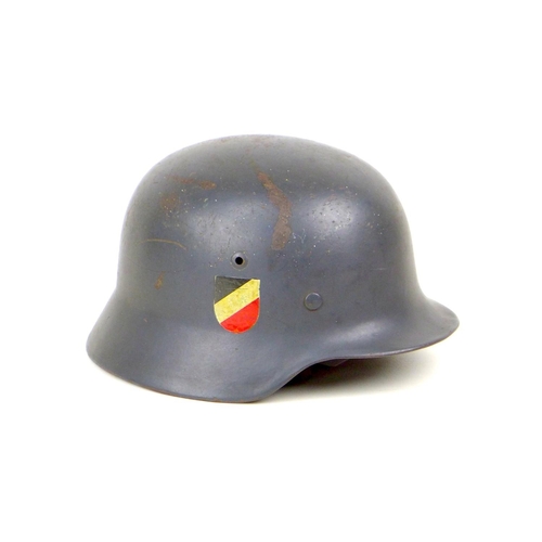 171 - A WWII era German Luftwaffe steel helmet, with leather lining and chin strap, its aluminium internal... 