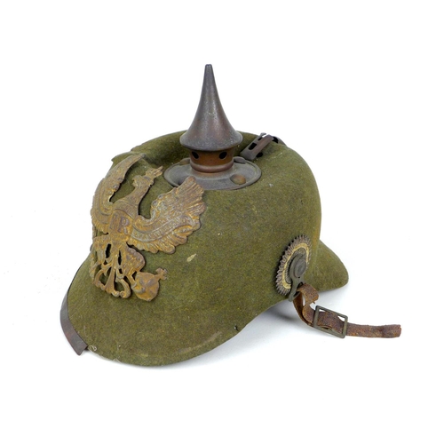 172 - A WWI German felt ersatz Pickelhaube helmet, with both helmet plates, faint stamped marks to the und... 