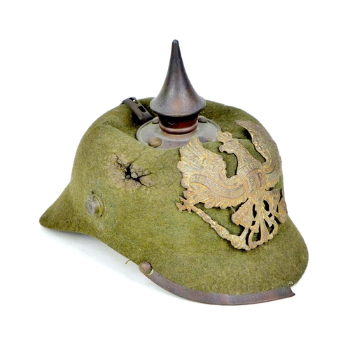 172 - A WWI German felt ersatz Pickelhaube helmet, with both helmet plates, faint stamped marks to the und... 