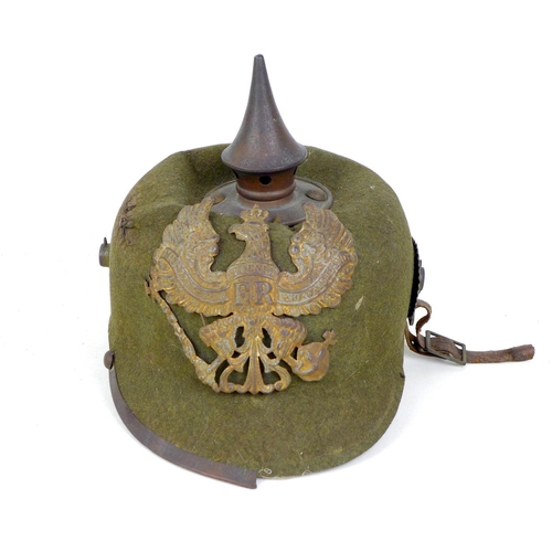 172 - A WWI German felt ersatz Pickelhaube helmet, with both helmet plates, faint stamped marks to the und... 