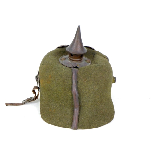 172 - A WWI German felt ersatz Pickelhaube helmet, with both helmet plates, faint stamped marks to the und... 