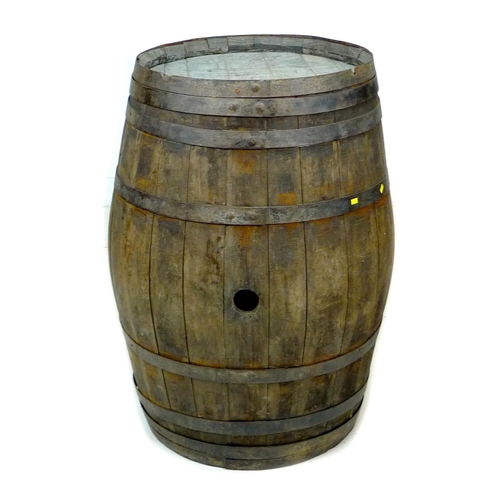 211 - A large oak coopered barrel with stopper hole and eight iron bands, a/f banding loose but still hold... 