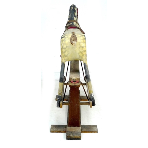 222 - A mid 20th century carved wooden rocking horse, dappled grey coat, red saddle, on a pine base with m... 