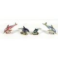 A group of four Royal Crown Derby paperweights, all modelled as dolphins, comprising 'Pink dolphins'... 