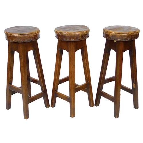 232 - Three vintage oak bar stools, with leather upholstered seats, 30 by 30 by 76cm high. (3)