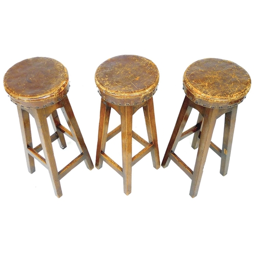 232 - Three vintage oak bar stools, with leather upholstered seats, 30 by 30 by 76cm high. (3)