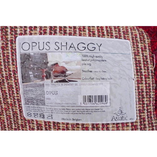 238 - A large contemporary 'Opus Shaggy' rug, with crimson ground, 245 by 345cm.