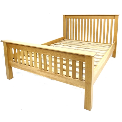 241 - A modern oak veneered double bed frame, with slatted ends, comprising headboard, footboard, two side... 