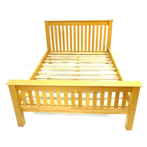 241 - A modern oak veneered double bed frame, with slatted ends, comprising headboard, footboard, two side... 