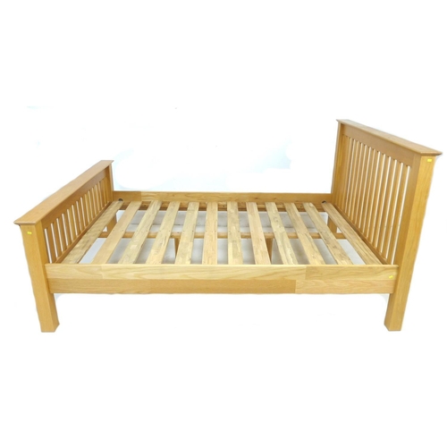 241 - A modern oak veneered double bed frame, with slatted ends, comprising headboard, footboard, two side... 