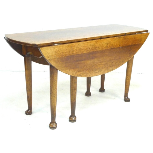 246 - A Georgian style oak oval drop leaf leaf dining table, late 20th century, raised on six tapering leg... 