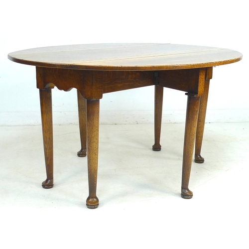 246 - A Georgian style oak oval drop leaf leaf dining table, late 20th century, raised on six tapering leg... 