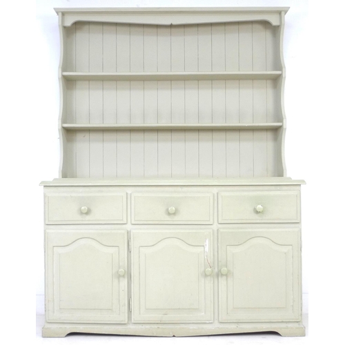 262 - A modern pine pale green painted dresser, with plate rack over three drawers and three cupboards wit... 