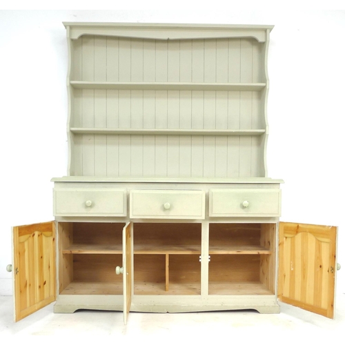 262 - A modern pine pale green painted dresser, with plate rack over three drawers and three cupboards wit... 