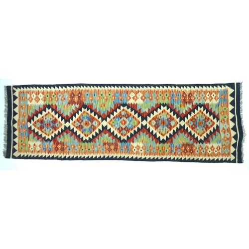 264 - A Caucasian ground Chobi Kelim runner, 188 by 61cm.