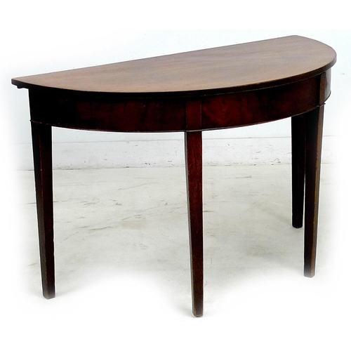 266 - An early 19th century mahogany demi lune side table, plain frieze, raised on tapering square section... 