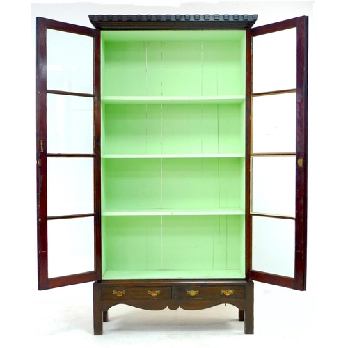 267 - A 20th century mahogany display cabinet, with double glazed doors, above a two drawer base with shap... 