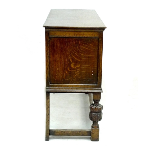 273 - An Old Charm dark stained sideboard, with carved decoration, two central drawers flanked by two cupb... 