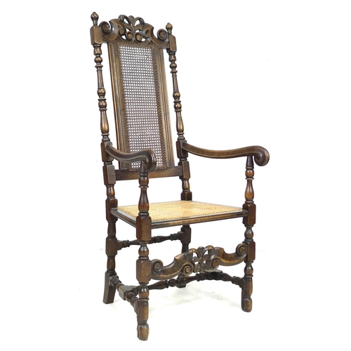 285 - A walnut 17th century style armchair, with carved decoration and caned seat and back, 59 by 66 by 13... 