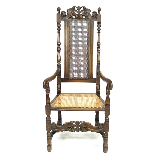 285 - A walnut 17th century style armchair, with carved decoration and caned seat and back, 59 by 66 by 13... 