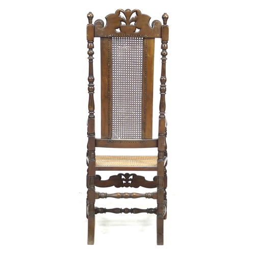 285 - A walnut 17th century style armchair, with carved decoration and caned seat and back, 59 by 66 by 13... 