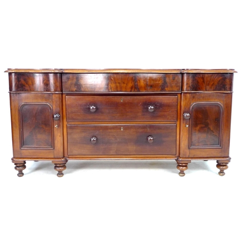 287 - A Victorian mahogany sideboard, with serpentine front, drawers flanked by two cupboards enclosing sh... 