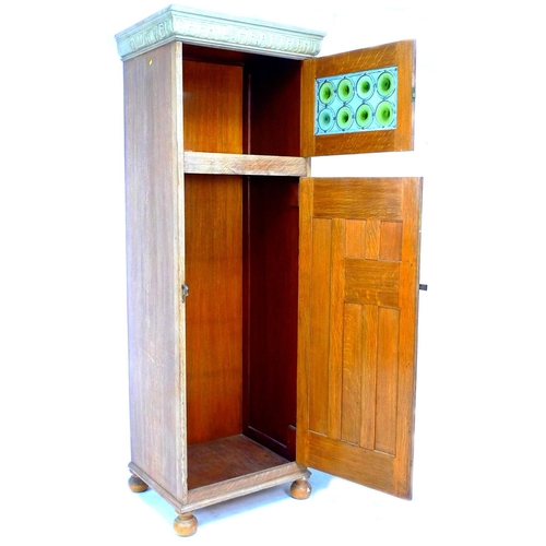 295 - A Liberty style oak Arts & Crafts single wardrobe, with motto to cornice 'WELL BEFALL HEARTH AND HAL... 