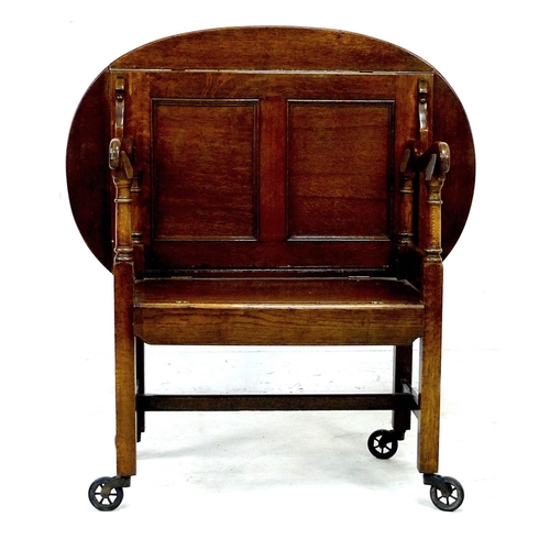 299 - An Edwardian oak unusual monk's bench/butler's tray tea trolley, bearing a 'Patent Applied For' plaq... 