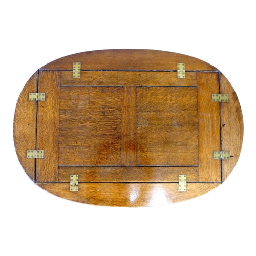 299 - An Edwardian oak unusual monk's bench/butler's tray tea trolley, bearing a 'Patent Applied For' plaq... 